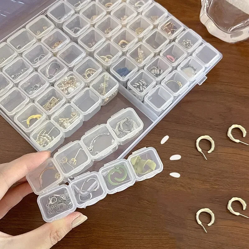 Boîte de rangement de bijoux en plastique à 28 grilles